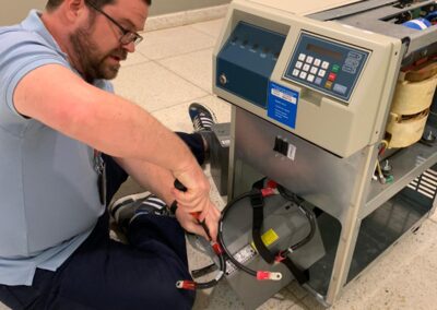 Logistician Alan Gilstrap removes batteries from a UPS in Santo Domingo, so that it can be decommissioned.