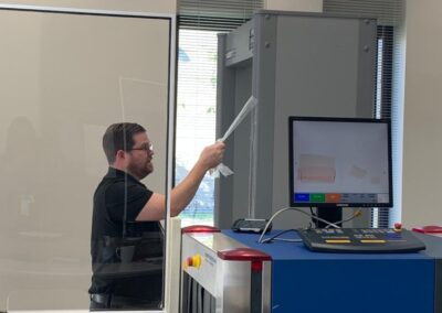 Florida Regional Center Logistician Alan Gilstrap prepares a newly arrived walk-thru metal detector for use at the US Embassy in Belmopan, Belize.