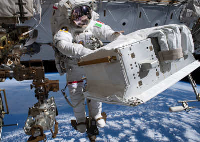 Astronaut in space, working on Mechanical Attach Device